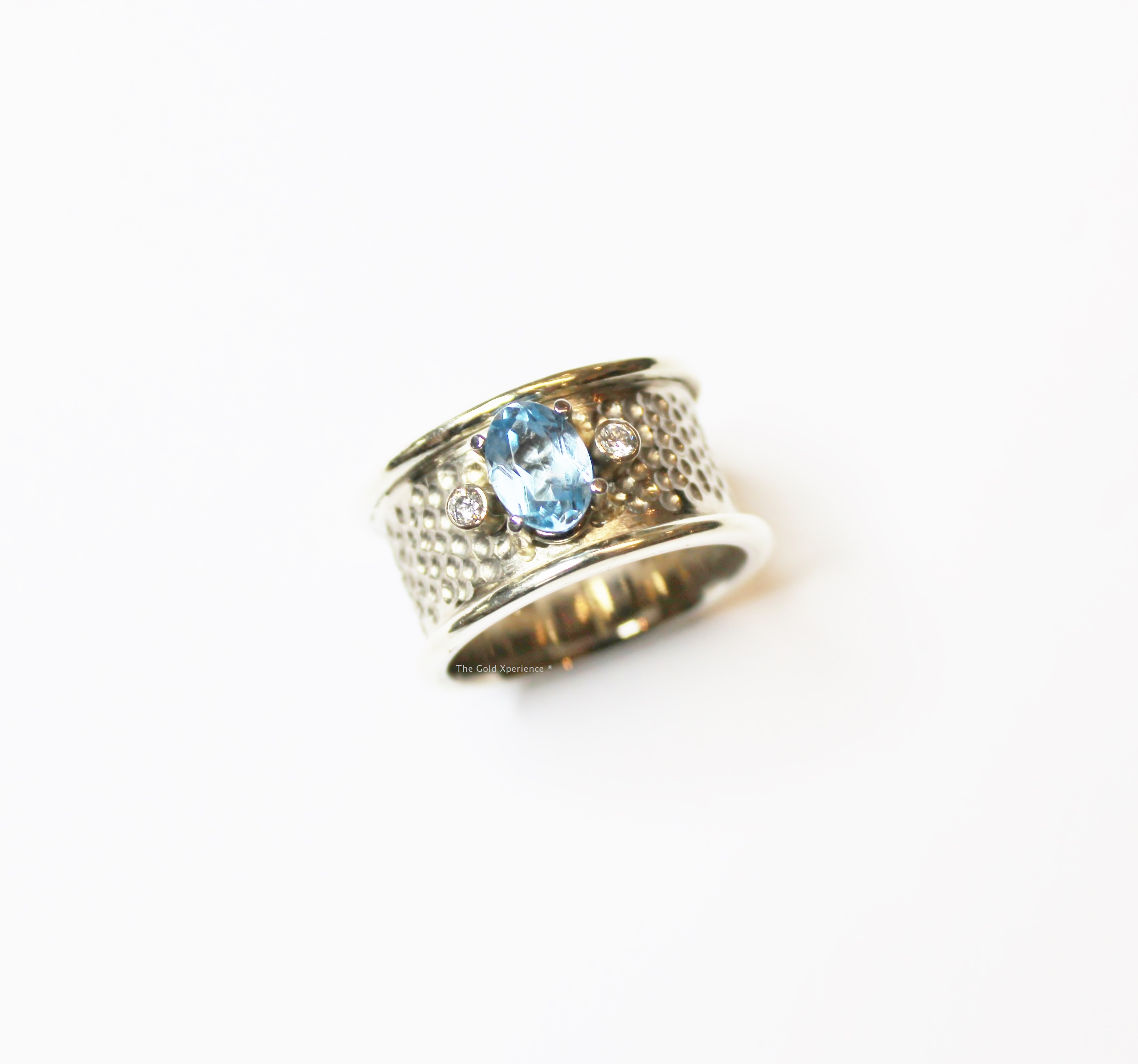 White gold band ring with topaz and diamonds